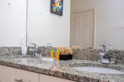 a bathroom counter with two sinks and a mirror at Marvelous 4 Bd Close To Disney at West Lucaya 8959 in Kissimmee