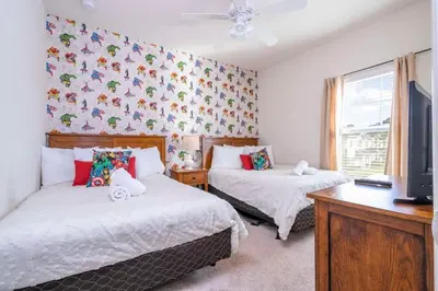 a bedroom with two beds and a tv in it at Marvelous 4 Bd Close To Disney at West Lucaya 8959 in Kissimmee