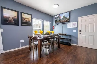 a dining room with blue walls and a table and chairs at Marvelous 4 Bd Close To Disney at West Lucaya 8959 in Kissimmee