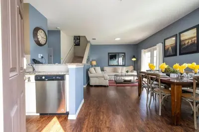 a kitchen and living room with a table and a clock at Marvelous 4 Bd Close To Disney at West Lucaya 8959 in Kissimmee