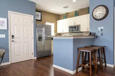a kitchen with a counter and a clock on the wall at Marvelous 4 Bd Close To Disney at West Lucaya 8959 in Kissimmee