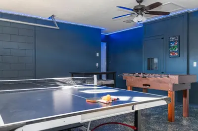 a ping pong room with a ping pong table and a ping pong at Magical 5-Bedroom Retreat w/ Pool, 3 Ensuite Bedrooms, Near Disney, and Internet! in Kissimmee