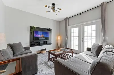 a living room with two couches and a tv at Freshly Redesigned 4BR at West Lucaya WL3211 in Kissimmee