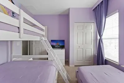 a bedroom with two bunk beds with purple walls at Freshly Redesigned 4BR at West Lucaya WL3211 in Kissimmee