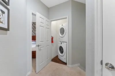 a white laundry room with a washer and dryer at Freshly Redesigned 4BR at West Lucaya WL3211 in Kissimmee