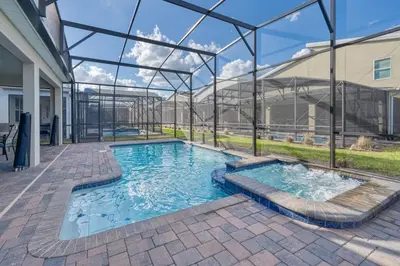 a swimming pool in a building with a glass enclosure at Family Paradise Space Themed Perfect Location in Kissimmee