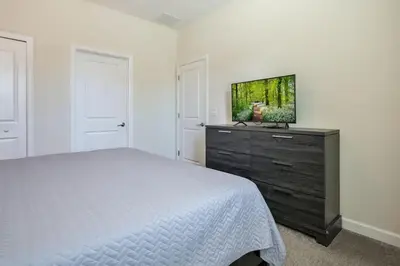 a bedroom with a bed and a tv on a dresser at Family Paradise Space Themed Perfect Location in Kissimmee