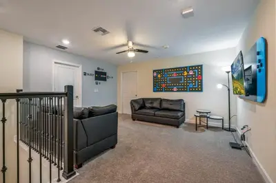 a living room with a couch and a chair at Family Paradise Space Themed Perfect Location in Kissimmee