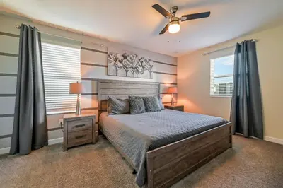 a bedroom with a bed and a ceiling fan at Family Paradise Space Themed Perfect Location in Kissimmee