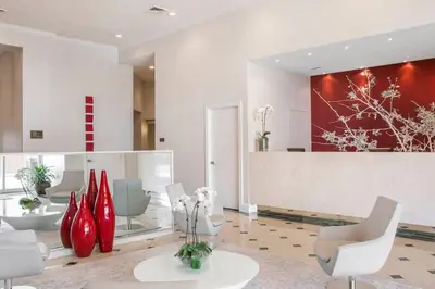 a lobby with white chairs and red vases at Universal and Convention Center Best Resort Studio in Orlando