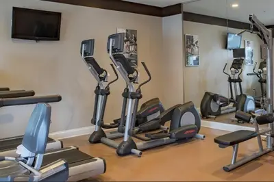 a gym with several cardio machines in a room at Universal and Convention Center Best Resort Studio in Orlando
