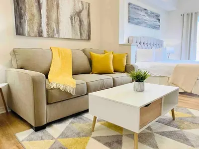 a living room with a couch and a coffee table at Universal and Convention Center Best Resort Studio in Orlando