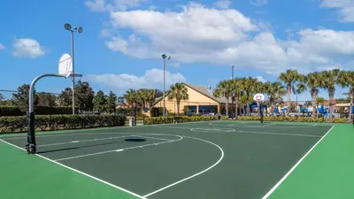 a tennis court at a resort with palm trees at 8931 Cuban Palm in Kissimmee