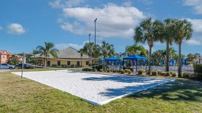 a playground with blue umbrellas and palm trees at 3071 Beach Palm in Kissimmee