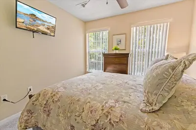 a bedroom with a large bed and a window at 8538 Crystal Cove in Kissimmee