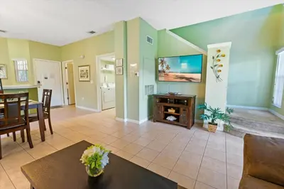 a living room with a tv and a table at 8538 Crystal Cove in Kissimmee