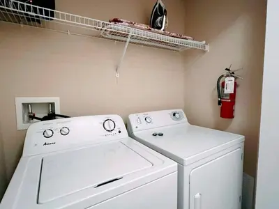a white washer and dryer in a laundry room at Beautiful 4 beds at Paradise Palms Resort in Kissimmee