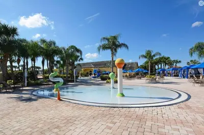 a fountain in the middle of a courtyard with palm trees at Beautiful 4 beds at Paradise Palms Resort in Kissimmee