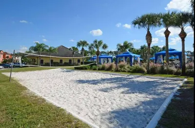 a walkway in front of a house with palm trees at Beautiful 4 beds at Paradise Palms Resort in Kissimmee