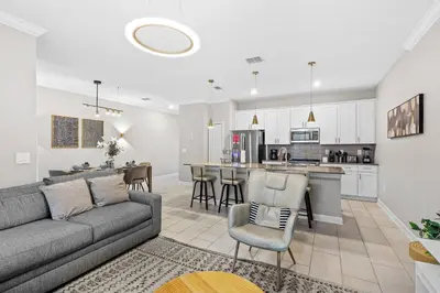 a living room with a couch and a kitchen at House with pool in resort in Kissimmee
