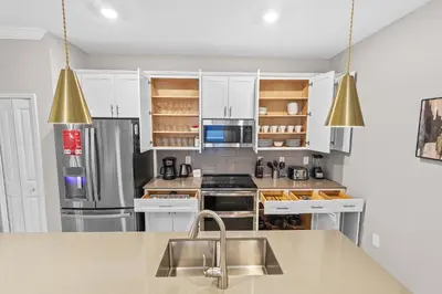 a kitchen with white cabinets and a stainless steel refrigerator at House with pool in resort in Kissimmee