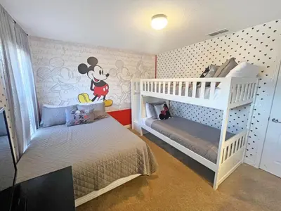 a room with a mickey mouse bedroom with a bunk bed at Banana Palm Paradise home in Kissimmee
