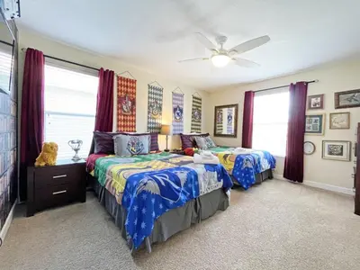 a bedroom with two beds and a ceiling fan at Banana Palm Paradise home in Kissimmee
