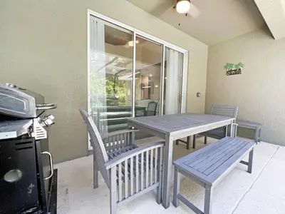a table and chairs in a room with a table and a window at Banana Palm Paradise home in Kissimmee