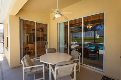 a dining room with a table and chairs and a pool at 2217 Wyndham Palms in Kissimmee