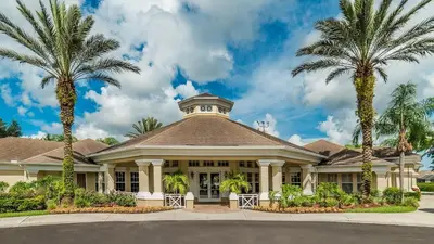 a house with palm trees in front of it at 2319 Silver Palm in Kissimmee