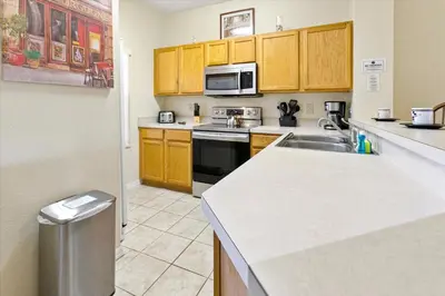 a kitchen with a sink and a microwave at 8569 Crystal Cove in Kissimmee