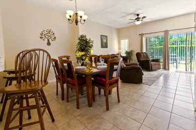 a dining room and living room with a table and chairs at 8569 Crystal Cove in Kissimmee