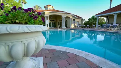 a villa with a swimming pool and a house at 8569 Crystal Cove in Kissimmee