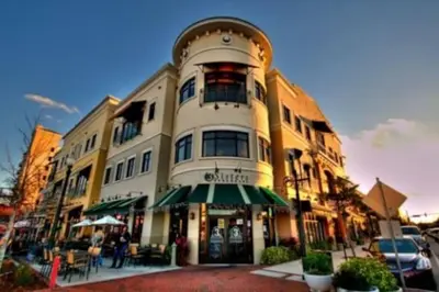 a building on a street with a cafe in front of it at 1 BD Apt close to Disney/Universal/Shopping/Dining in Kissimmee