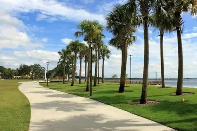 a path with palm trees in a park at 1 BD Apt close to Disney/Universal/Shopping/Dining in Kissimmee