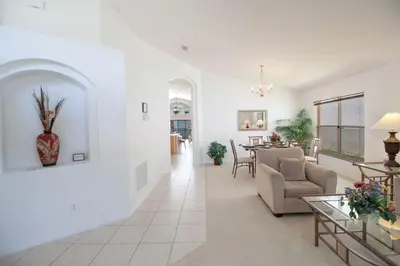 a living room with a couch and a table at Private Pool Home at Seasons Community in Kissimmee