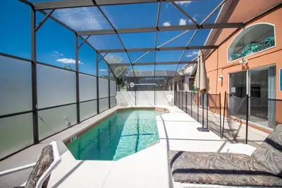 a swimming pool in a house with a glass ceiling at Private Pool Home at Seasons Community in Kissimmee