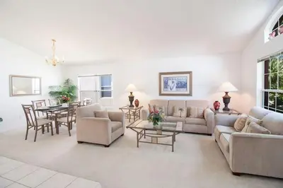 a living room with a couch and a table at Private Pool Home at Seasons Community in Kissimmee