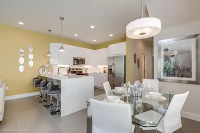 a kitchen and dining room with a table and chairs at Luxury Retreat with Pool in Orlando