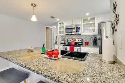 a kitchen with white cabinets and a counter top at Kissimmee Condo with Perks 6 Mi to Disney World! in Kissimmee
