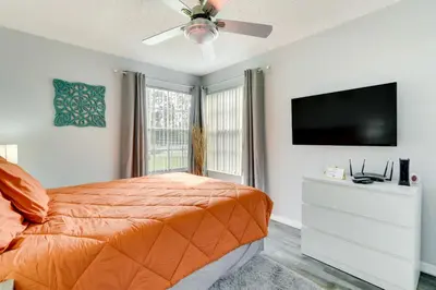 a bedroom with a bed and a flat screen tv at Kissimmee Condo with Perks 6 Mi to Disney World! in Kissimmee