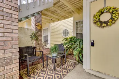 a porch with chairs and a wreath on a house at Kissimmee Condo with Perks 6 Mi to Disney World! in Kissimmee