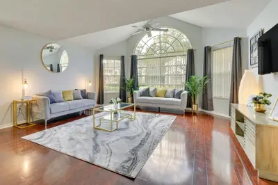 a living room with two couches and a table at Kissimmee Condo with Perks 6 Mi to Disney World! in Kissimmee