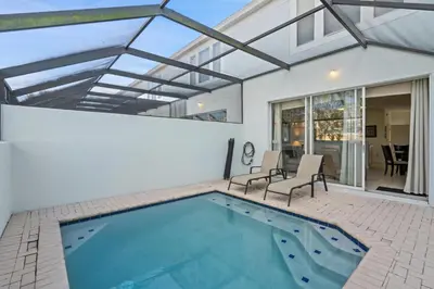a swimming pool in a house with a glass roof at 2563 Maneshaw in Orlando