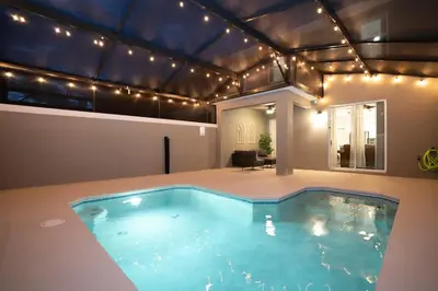 a large swimming pool in a house with lights at Wonderfull home near Disney & FREE Waterpark 2421 in Kissimmee