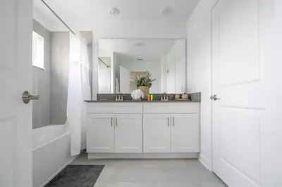 a white bathroom with a sink and a bath tub at Amazing Disney resort style & FREE Waterpark 2481 in Kissimmee