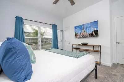 a bedroom with a bed and a large window at Amazing Disney resort style & FREE Waterpark 2481 in Kissimmee