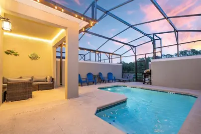 a swimming pool with a pergola and a patio at Disney adventure resort style free waterpark2633 in Kissimmee