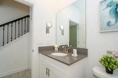 a bathroom with a sink and a mirror at Disney adventure resort style free waterpark2633 in Kissimmee