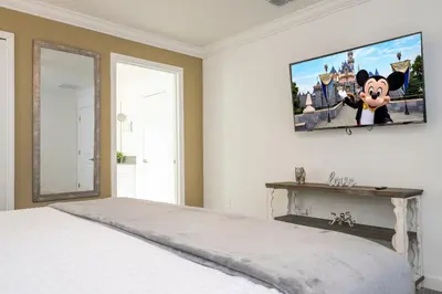 a bedroom with a bed and a tv on the wall at Disney adventure resort style free waterpark2633 in Kissimmee